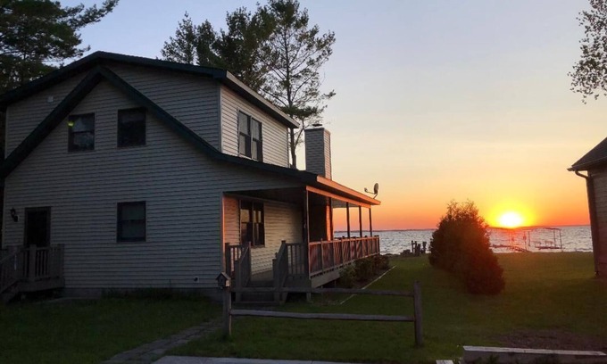 Onaway House | Black Lake sunset waterfront home 78' private sandy beach on prestine Black Lake