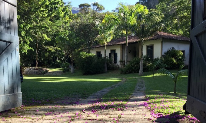 Correas House | Colonial house with a smaller house on the edge of a river and along the forest.