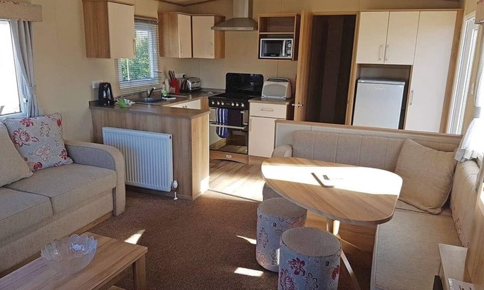 Kilcreggan House | Contemporary 12ft-wide caravan with one double and two twin.