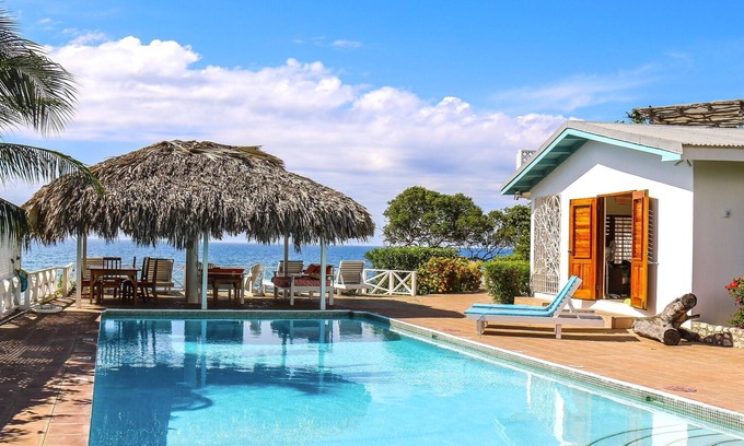 Treasure Beach Villa | Doubloon Villa, large pool and sandy beach at heart of Treasure Beach
