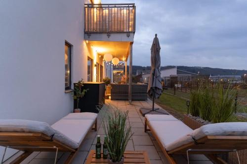 Bastad House | Earthy Ground Floor Home with Patio Sunbeds Greenery