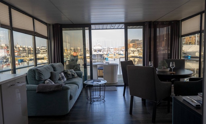 Flensburg Boat Rental | Houseboat Luv in Sonwik harbor with a view of Denmark