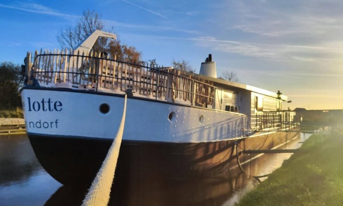 Otterndorf Boat Rental | Houseboat with hot tub, sauna, wood-burning stove, air conditioning, lounge, sun deck and garden with dinghy directly behind the dike in Otterndorf