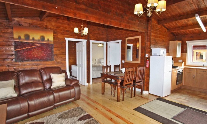 Pontardulais Cottage | Lake side log cabin peacefully situated and each enjoying fabulous lake views.