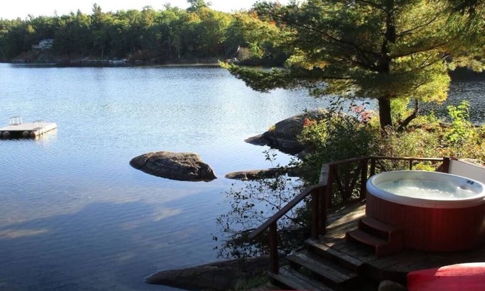 Town of Hermon Cottage | Lakeside Cottage near Adirondacks, Hot Tub, Pontoon Boat, Kayaks & Paddle Board