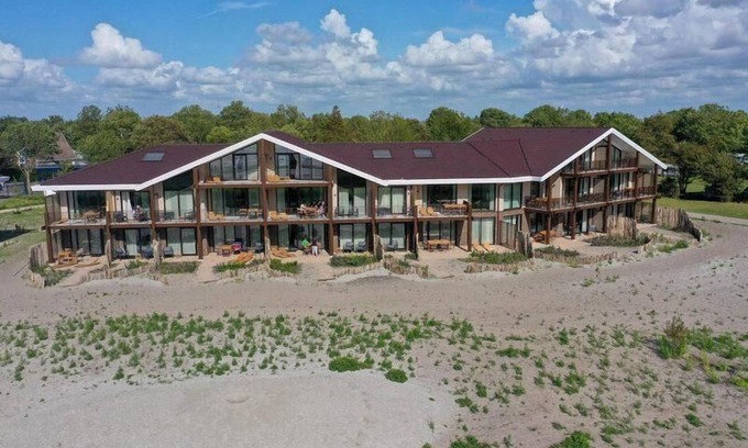 Workum Apartment | Luxury 4-person apartment with sauna, bathtub, and balcony overlooking the IJsselmeer. Ideal for a relaxing stay by the water.