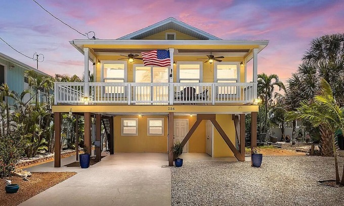 Fort Myers Beach House | Ostego Charm: Open floor plan, pool, porch, lush landscape—walk-able to the Beach!