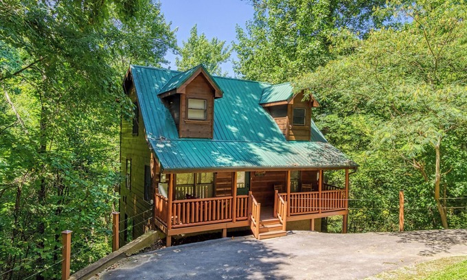 Gatlinburg - Pigeon Forge Cabin | Private Wooded Setting! Theater Room! Centrally Located! 3 Decks! Fun Game Room