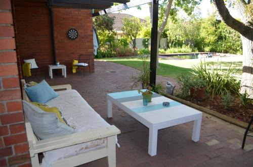 Die Boord House | Retro Red Stone Villa with pool & lush garden