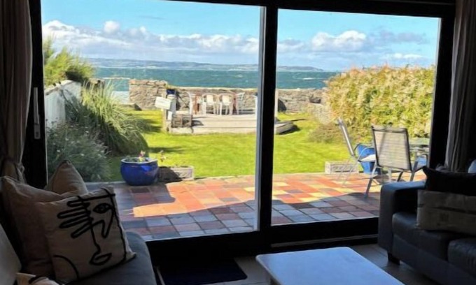 Bangor Cottage | Splash Cottage Beach house with sea touching back garden