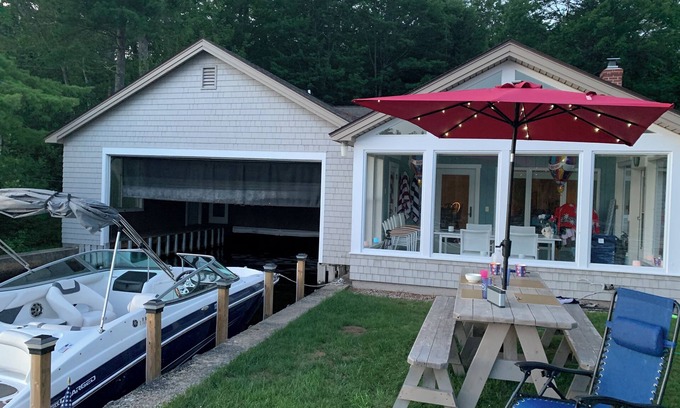 Sanbornville House | Stunning lakefront home with a boathouse, private dock, firepit and lake views