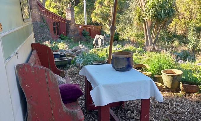 Akaroa House | Stylish vintage caravan on a farm over looking bush and river.