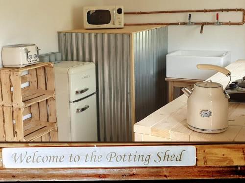 Kilgetty Apartment | The Potting Shed near Tenby, 100" Projector, Four poster bed, On-site HOT TUB access via Spa Pack