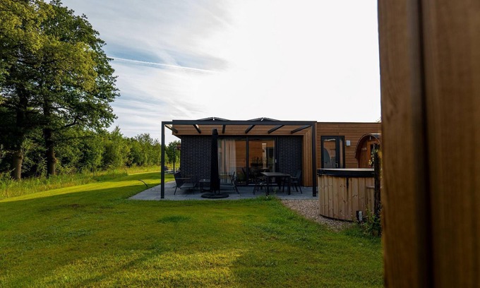 Lattrop House | This holiday home with a fully enclosed dog fence, private sauna and hot tub features a cosy, homely living room with open kitchen, 2 bedrooms and a spacious outdoor area.