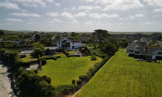 Holyhead House | Trefonen House- Beachfront with hot tub & BBQ hut
