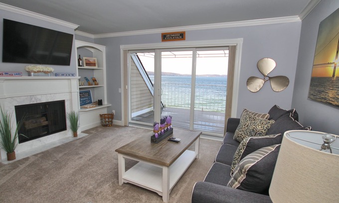 Boyne City Condo | Vaulted Ceilings + Prime Lake Charlevoix Views | Fireplace | Private Patio|