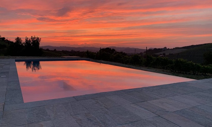 Castagnole delle Lanze Villa | Villa with vineyards, infinity pool, views of an UNESCO castle and the alps.