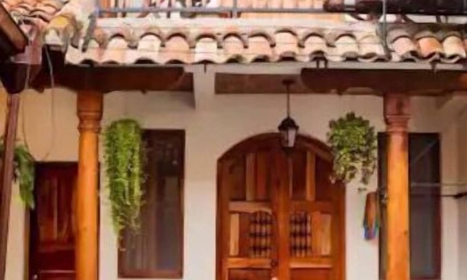 Granada House | You’ll know that you have rented a historic colonial home when you pass through huge, antique front doors framed by 3 foot-thick adobe walls. Lounge on the shallow, submerged bench seats in the pool or in the hammocks hanging between 12 foot wooden c