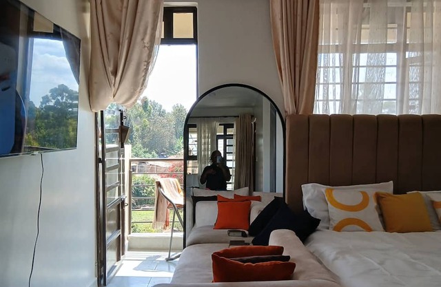 A cozy studio Apartment with a balcony.